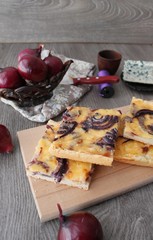 Tart flambee with purple onions, bacon and apples (Flammkuchen), selective focus