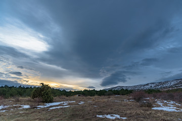 Beautiful dramatic sky with sunset in the winter forest. Russia, Stary Krym.