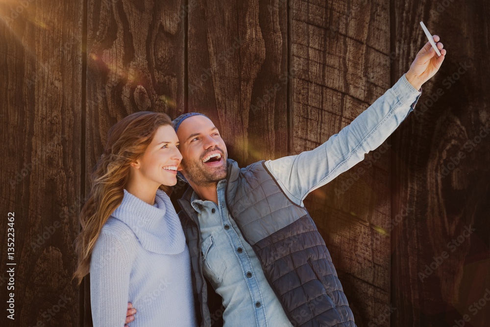 Sticker Composite image of happy young couple taking selfie