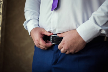 man putting on a belt, Businessman, Politician, man's style, male hands closeup, American businessman, European businessman, a businessman from Asia, People, business, fashion and clothing concept