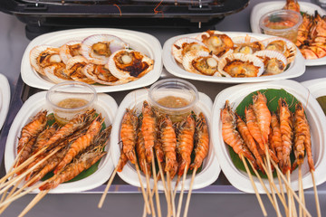 bbq king prawns and scallops at a buffet table, seafood barbecue