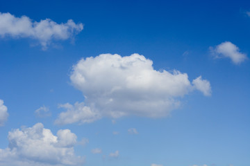 Fototapeta na wymiar White shapeless clouds on the blue sky