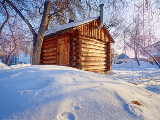 Photo of beautiful wooden outhouse with roof under the snow