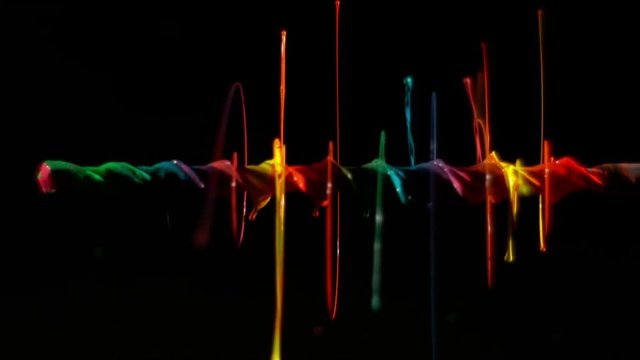 Paint spinning on a power drill towards camera in neon brilliance