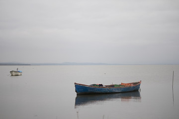 Naklejka na ściany i meble Small Boat on the Lake