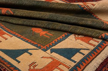 Close up of a fine Turkish konya oriental carpet with figural motifs