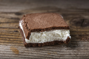 Close up of one broken cake filled with milk and yogurt cream ov