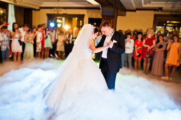 Amazing first wedding dance of wedding couple with heavy smoke a
