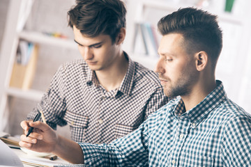 Portrait of white men doing paperwork