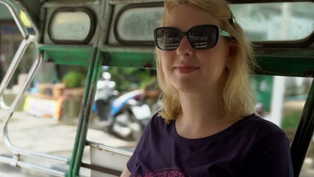 Blonde woman in asian pickup car in sun glasses