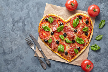 Heart shaped pizza love concept Valentine's Day flat lay homemade dinner Italian food. Olives,...