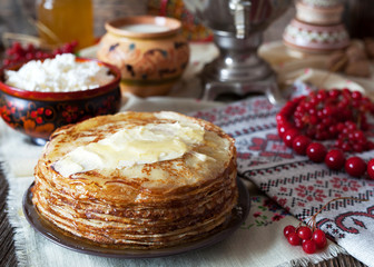 Traditional Ukrainian or Russian pancakes with cottage cheese and sour cream on napkins with...