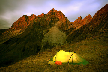 Last glow of daylight and an illuminated tent.
