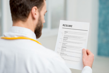 Doctor reading resume for job hiring in the hospital