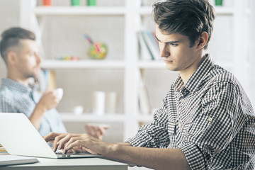 Man in office using laptop