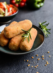Chicken croquettes served with vegetable salad