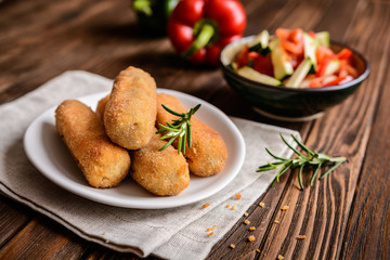 Chicken croquettes served with vegetable salad