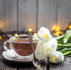 white tulips and a Cup of tea