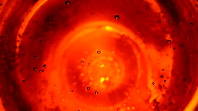 Abstract bubbles in water like in space against orange yellow background, or fizzy water in glass close up