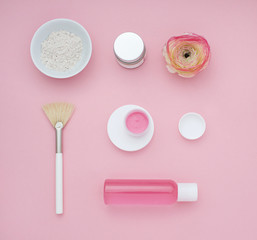 Natural cosmetic pink flat lay with flower. Top view.
