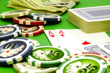 Poker table with chips, money and playing cards
