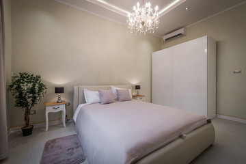 Modern designed bedroom with brick wall
