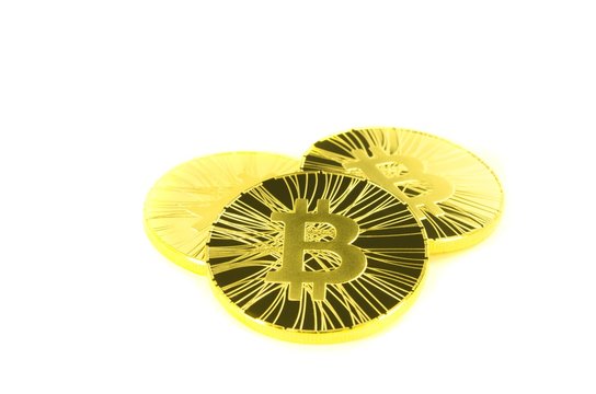 Three golden bitcoin coin on white background