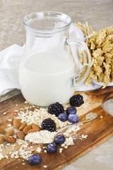 Ecological oat milk with berries and mussels on wooden desk
