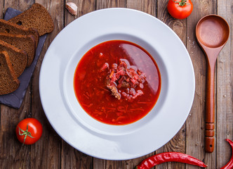 Beet soup in white plate with vegetables