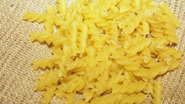 Pasta on sacking, while rotating, close-up.slow motion