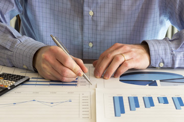 office desk with charts , histograms and financial documents