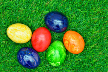 Easter eggs on green Grass / close up of colorful easter eggs on green grass, horizontal
