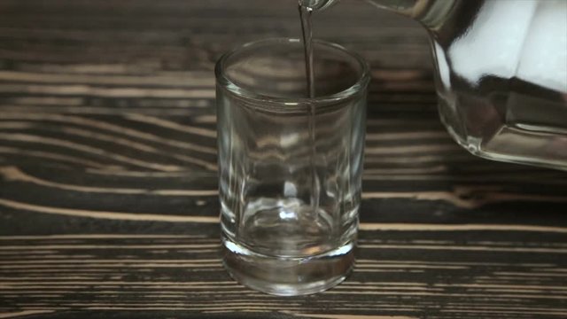Poured a glass of vodka, close-up . Full hd video