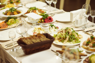 table set service with silverware and glass stemware at restaurant before party