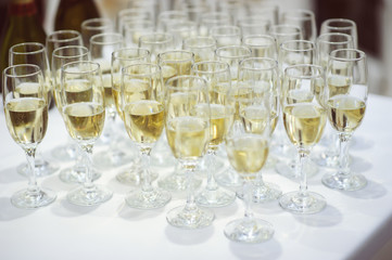 row of glasses filled with champagne