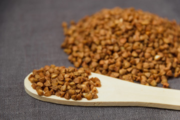 buckwheat grains and wooden spoon