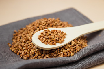 buckwheat grains and wooden spoon