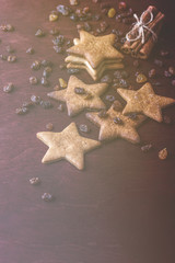 Close up of homemade ginger cookies, cinnamon with raisins on a red wooden table