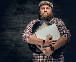 A man holds vinyl records.