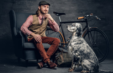 A man with Ireland setter dog.