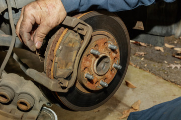 Removing spring clip from front disk brake shoe