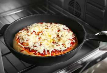 Pizza baking in oven