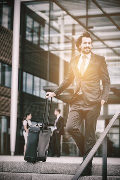 Businessman standing with suitcase