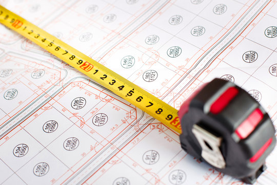 Construction tape on the table. Construction drawings and roulet