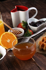 breakfast on table with waffles, croissants, coffe and juice