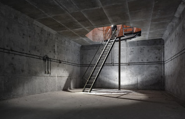Concrete room under ground with a ladder to the surface from which the light comes. Technical room...