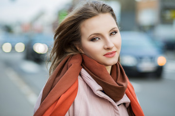 Stylish Pretty Young Woman in Autumn Fashion clothing walking the city Looking at you the Camer