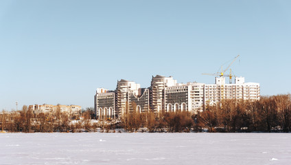 Fototapeta na wymiar Winter Cityscape with modern buildings or houses and blue sky in sunny day