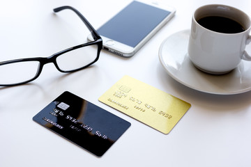 credit card, keyboard, smartphone and coffee cup on white background