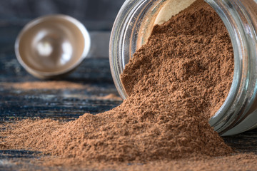 Ground Cinnamon Spilled from a Spice Jar